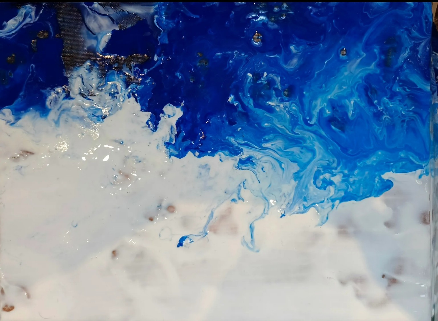 Abstract acrylic painting in deep cobalt and bright blue flowing into white, with wave-like currents and small gold flecks.